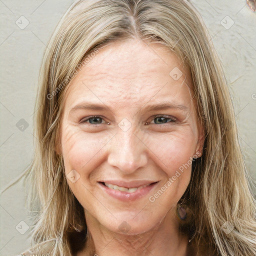 Joyful white adult female with long  brown hair and green eyes