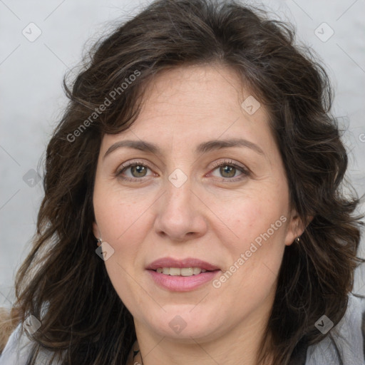 Joyful white adult female with long  brown hair and brown eyes