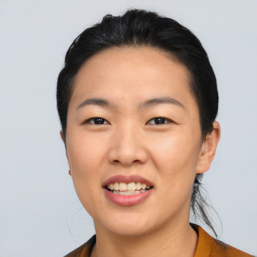 Joyful asian young-adult female with short  black hair and brown eyes