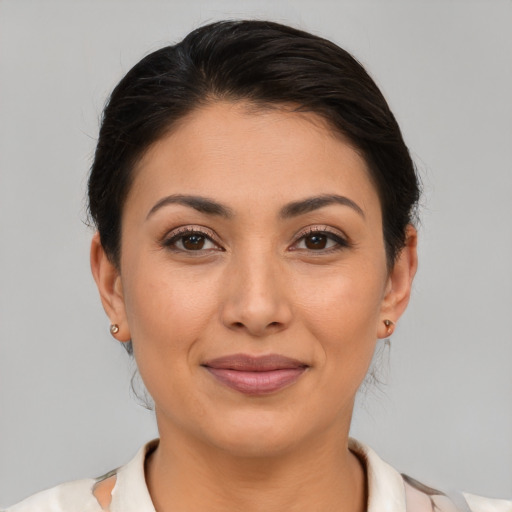 Joyful latino young-adult female with short  brown hair and brown eyes