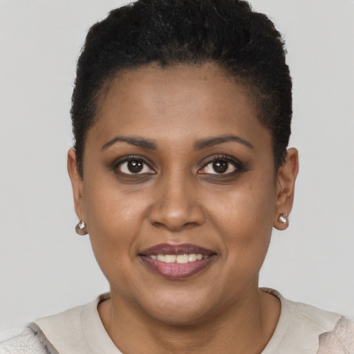 Joyful black young-adult female with short  brown hair and brown eyes