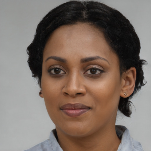 Joyful black young-adult female with medium  black hair and brown eyes