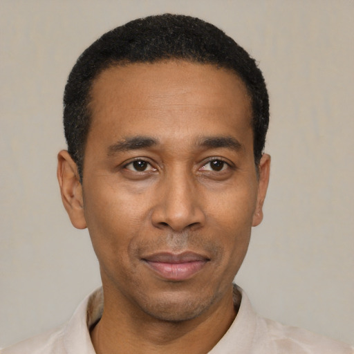 Joyful latino adult male with short  black hair and brown eyes