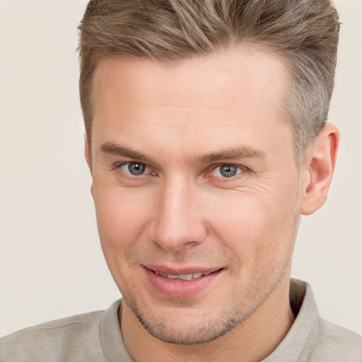 Joyful white adult male with short  brown hair and grey eyes