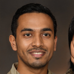 Joyful latino young-adult male with short  brown hair and brown eyes