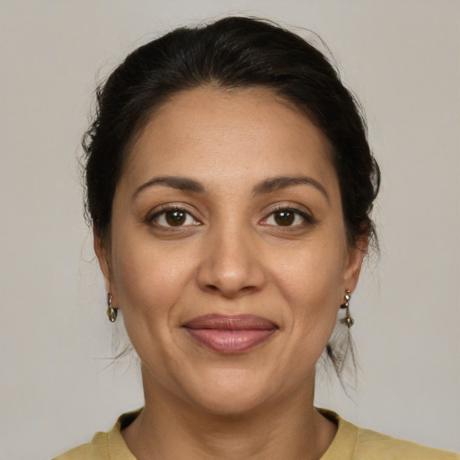 Joyful latino young-adult female with medium  brown hair and brown eyes