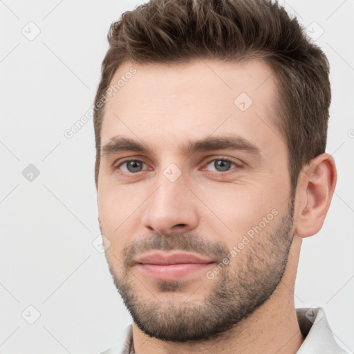 Joyful white young-adult male with short  brown hair and brown eyes