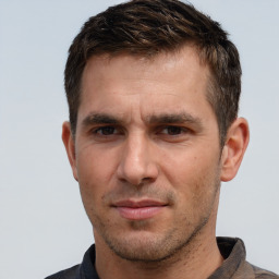 Joyful white adult male with short  brown hair and brown eyes