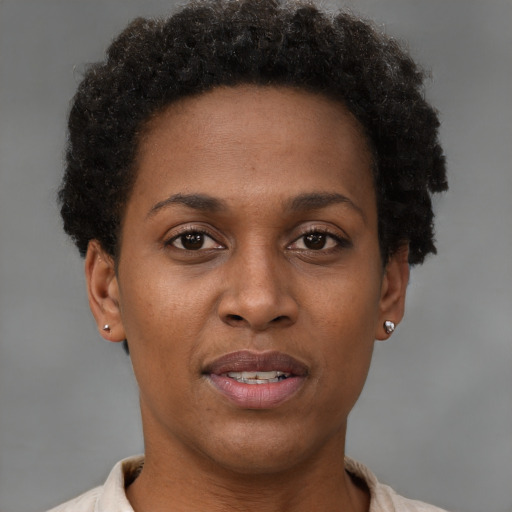 Joyful black young-adult female with short  brown hair and brown eyes