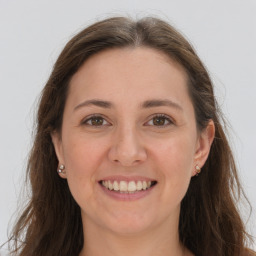 Joyful white young-adult female with long  brown hair and grey eyes