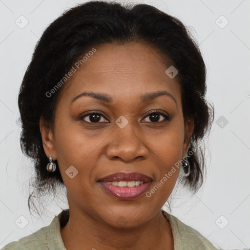 Joyful black adult female with medium  brown hair and brown eyes