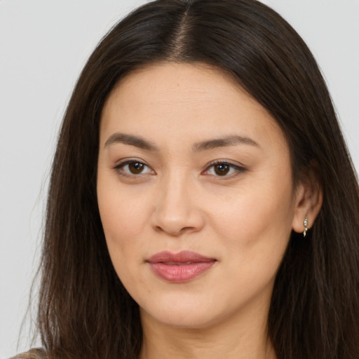 Joyful asian young-adult female with long  brown hair and brown eyes