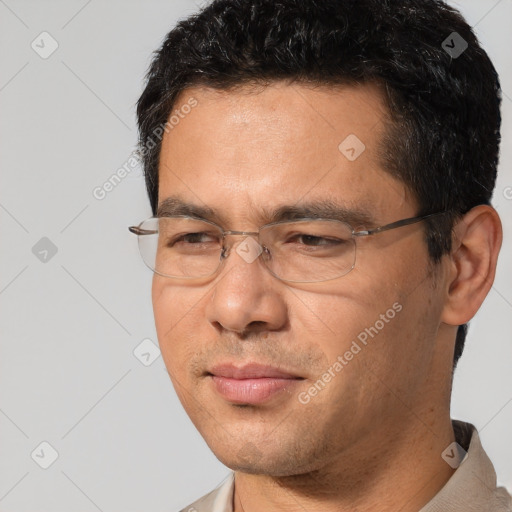 Joyful white adult male with short  black hair and brown eyes