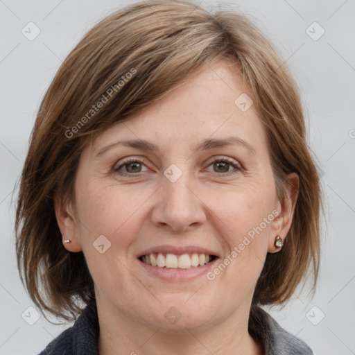 Joyful white adult female with medium  brown hair and grey eyes