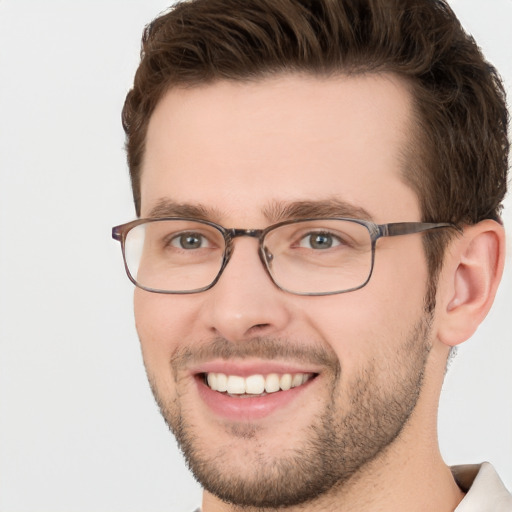 Joyful white young-adult male with short  brown hair and green eyes