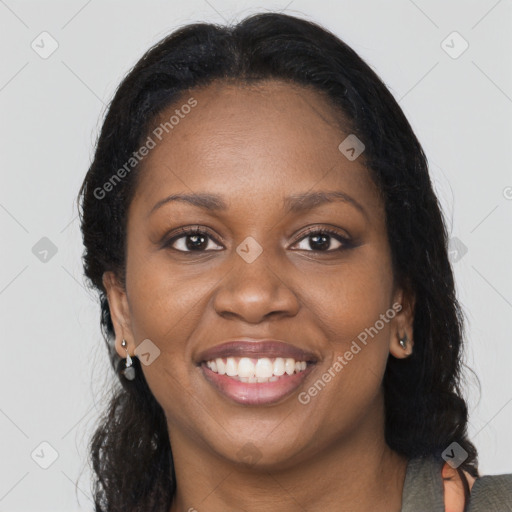 Joyful black young-adult female with long  brown hair and brown eyes