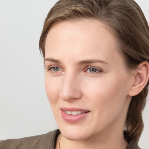 Joyful white young-adult female with long  brown hair and grey eyes