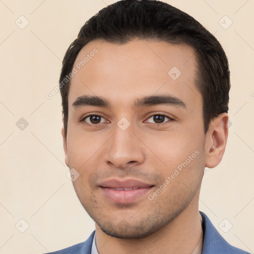 Joyful white young-adult male with short  black hair and brown eyes