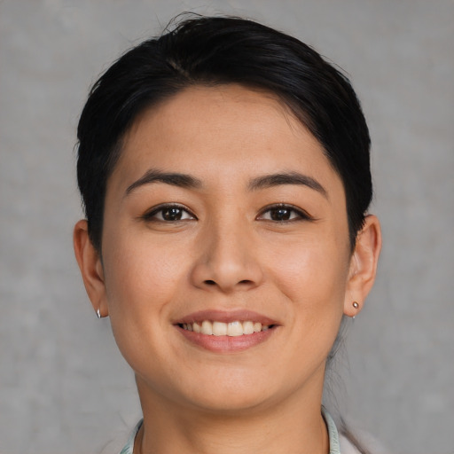 Joyful asian young-adult female with short  black hair and brown eyes
