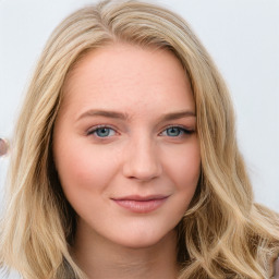 Joyful white young-adult female with long  brown hair and blue eyes