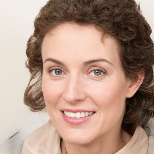 Joyful white young-adult female with medium  brown hair and blue eyes