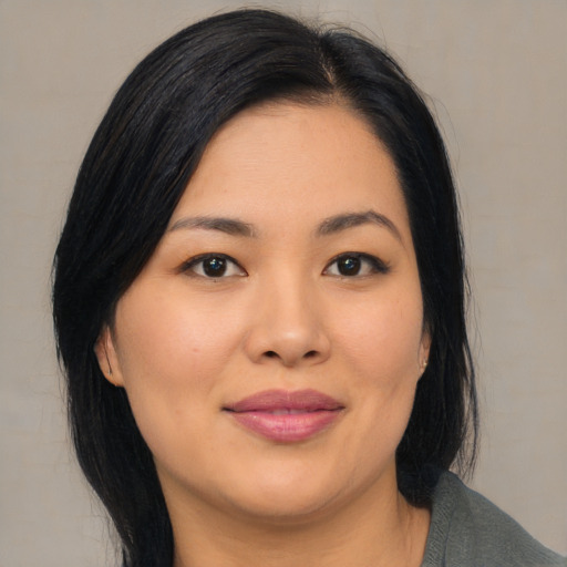 Joyful asian young-adult female with medium  black hair and brown eyes
