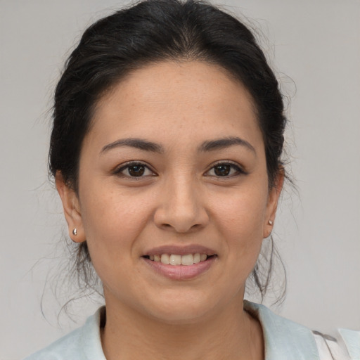 Joyful latino young-adult female with medium  brown hair and brown eyes