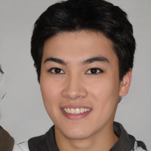 Joyful white young-adult male with medium  black hair and brown eyes