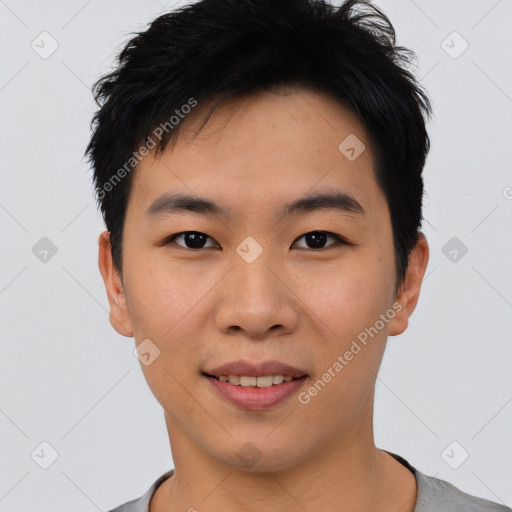 Joyful asian young-adult male with short  black hair and brown eyes