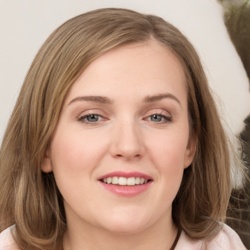 Joyful white young-adult female with medium  brown hair and grey eyes