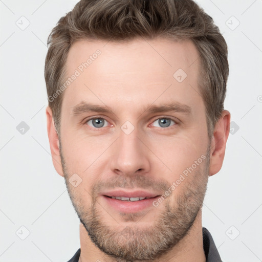 Joyful white young-adult male with short  brown hair and grey eyes