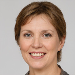 Joyful white adult female with medium  brown hair and grey eyes