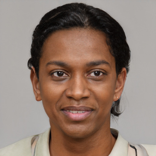 Joyful black young-adult female with short  black hair and brown eyes
