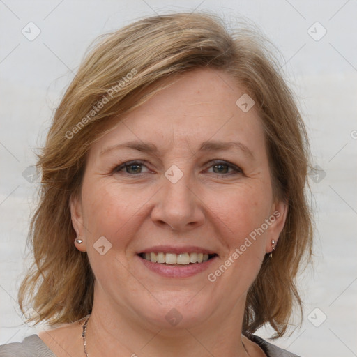 Joyful white adult female with medium  brown hair and blue eyes