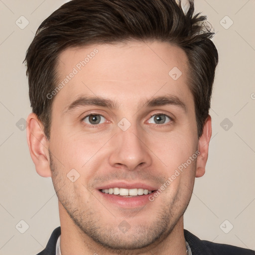 Joyful white young-adult male with short  brown hair and grey eyes