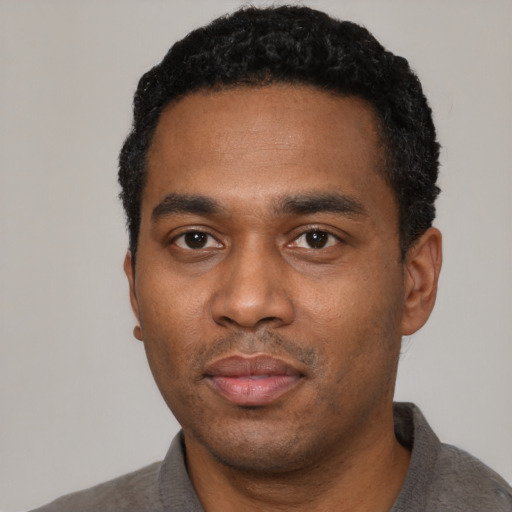Neutral black young-adult male with short  black hair and brown eyes