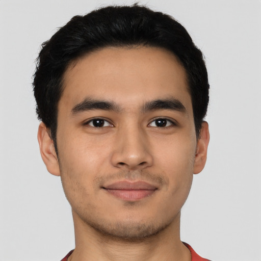 Joyful latino young-adult male with short  brown hair and brown eyes