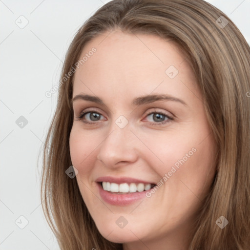 Joyful white young-adult female with long  brown hair and grey eyes