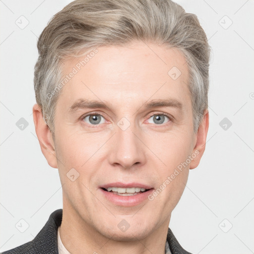 Joyful white adult male with short  brown hair and grey eyes