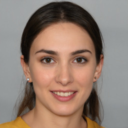 Joyful white young-adult female with medium  brown hair and brown eyes