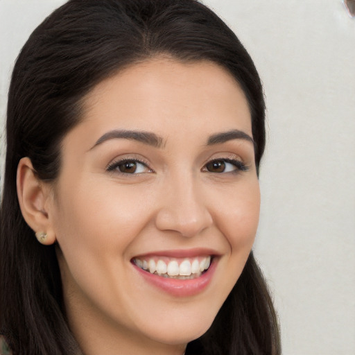 Joyful white young-adult female with long  brown hair and brown eyes