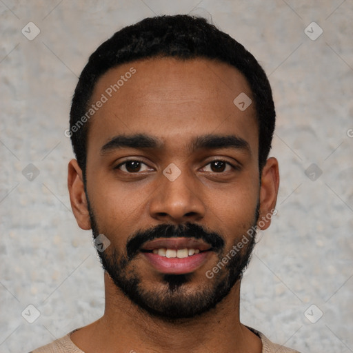 Joyful black young-adult male with short  black hair and brown eyes