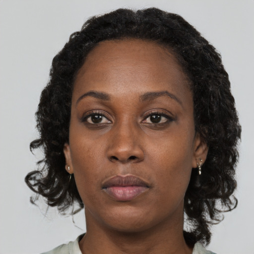 Neutral black young-adult female with medium  brown hair and brown eyes
