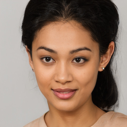 Joyful latino young-adult female with medium  black hair and brown eyes