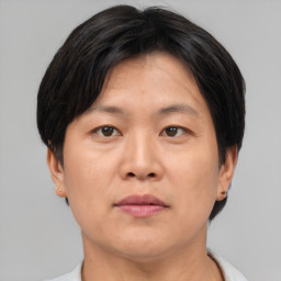 Neutral asian adult female with short  brown hair and brown eyes