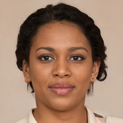 Joyful black young-adult female with medium  brown hair and brown eyes