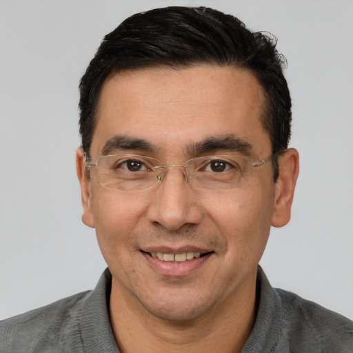 Joyful white adult male with short  black hair and brown eyes