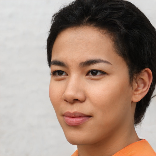 Joyful asian young-adult female with short  brown hair and brown eyes
