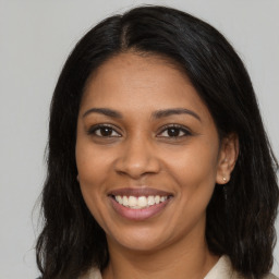 Joyful black young-adult female with medium  brown hair and brown eyes