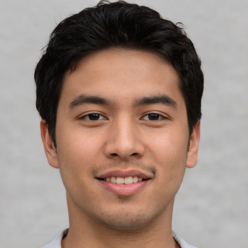 Joyful asian young-adult male with short  brown hair and brown eyes